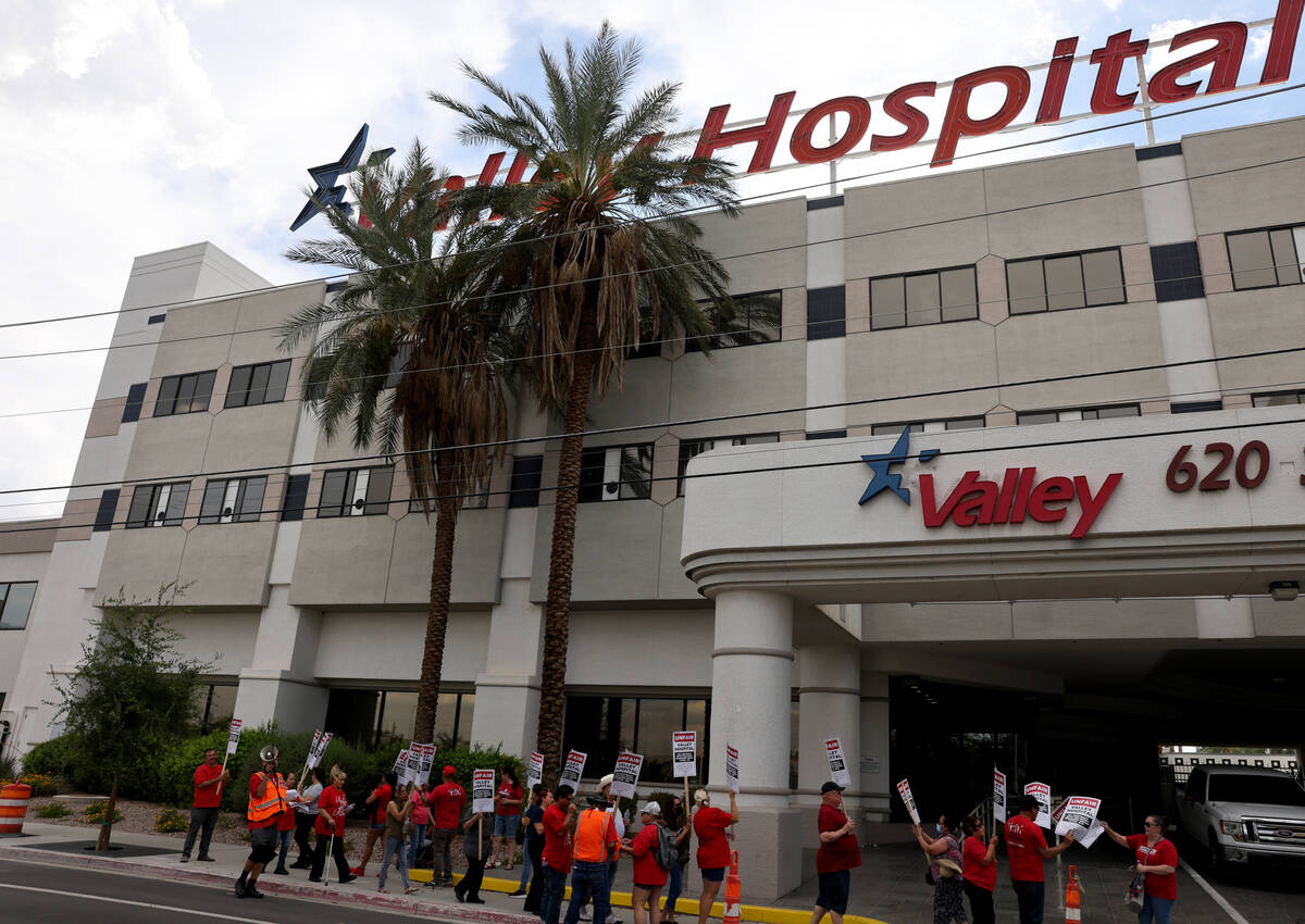 Members of the Culinary Union picket Valley Hospital Medical Center in Las Vegas in August 2022 ...