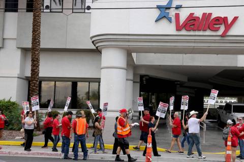 Members of the Culinary Union picket Valley Hospital Medical Center in Las Vegas in August 2022 ...