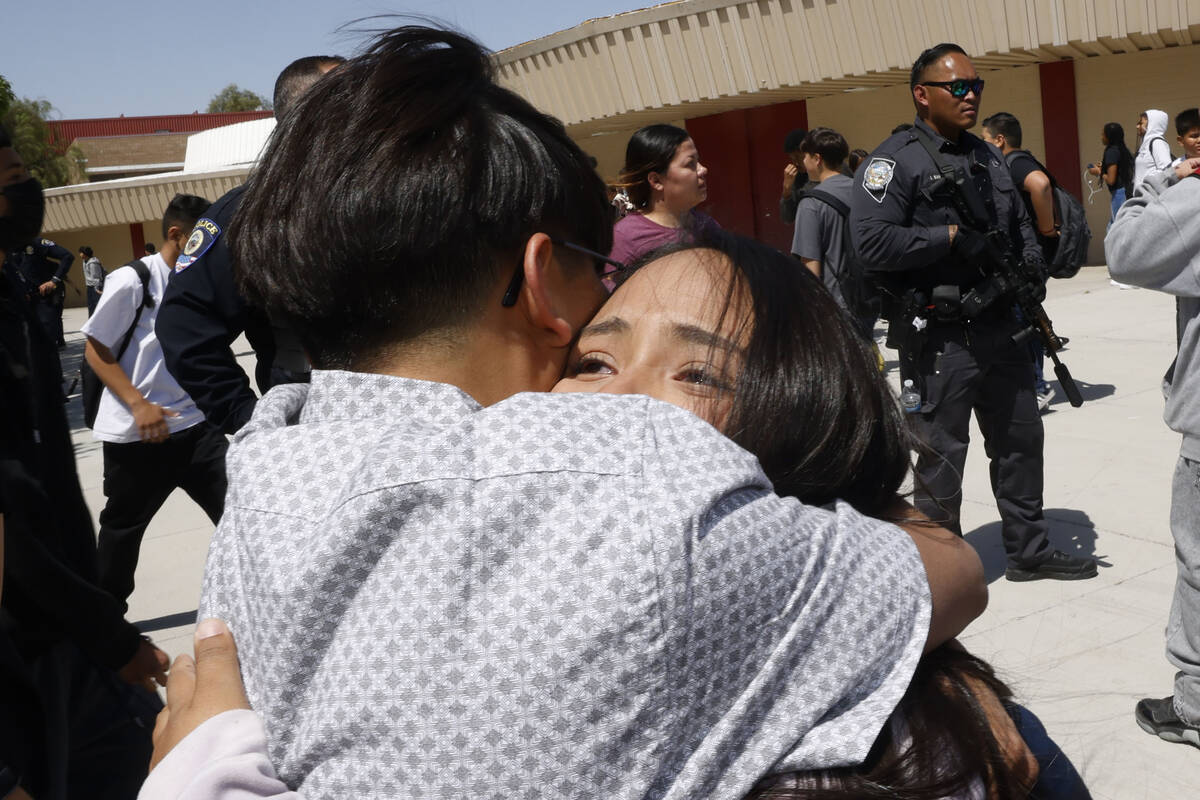 Kasey Caballero, 12, seventh grader, facing to the camera, receives a hug from her sister Steph ...