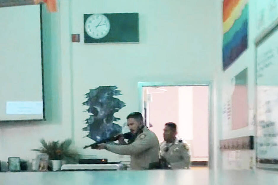Officers clear a classroom at Ed Von Tobel Middle School, Monday, May 8, 2023, after a shooting ...