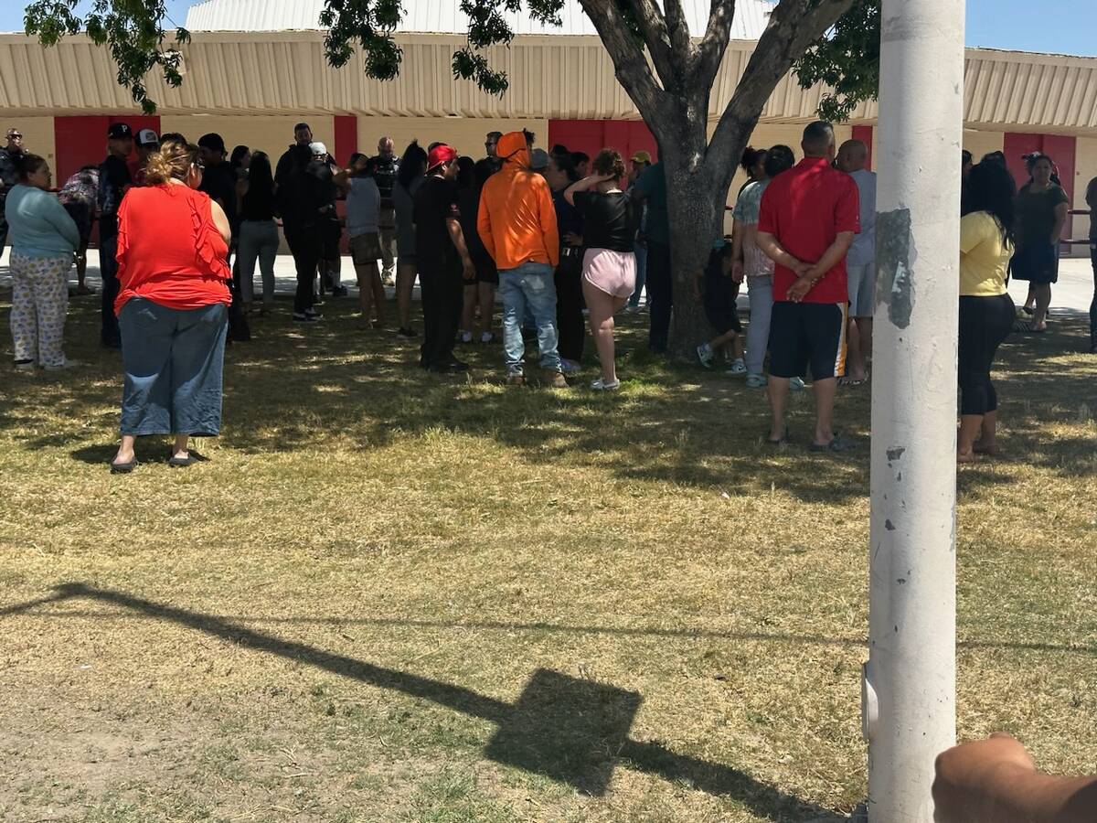 People stand outside of Ed Von Tobel Middle School as Clark County School District police respo ...