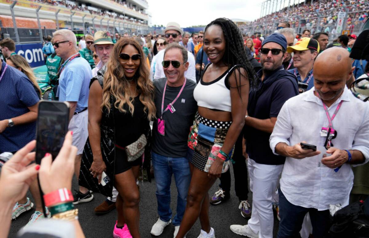 Serena Williams, left, and sister Venus Williams, right, pose for a photo with another race goe ...