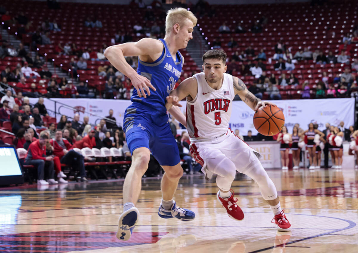 UNLV guard Jordan McCabe (5) drives against Air Force Falcons forward Rytis Petraitis (31) duri ...