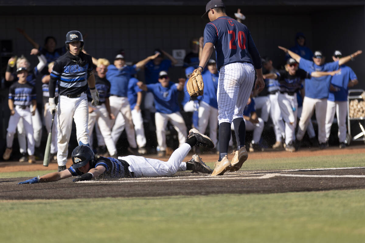 Basic’s Randall Riley slides into home plate while Coronado’s Jase Pashales (20) can’t ma ...