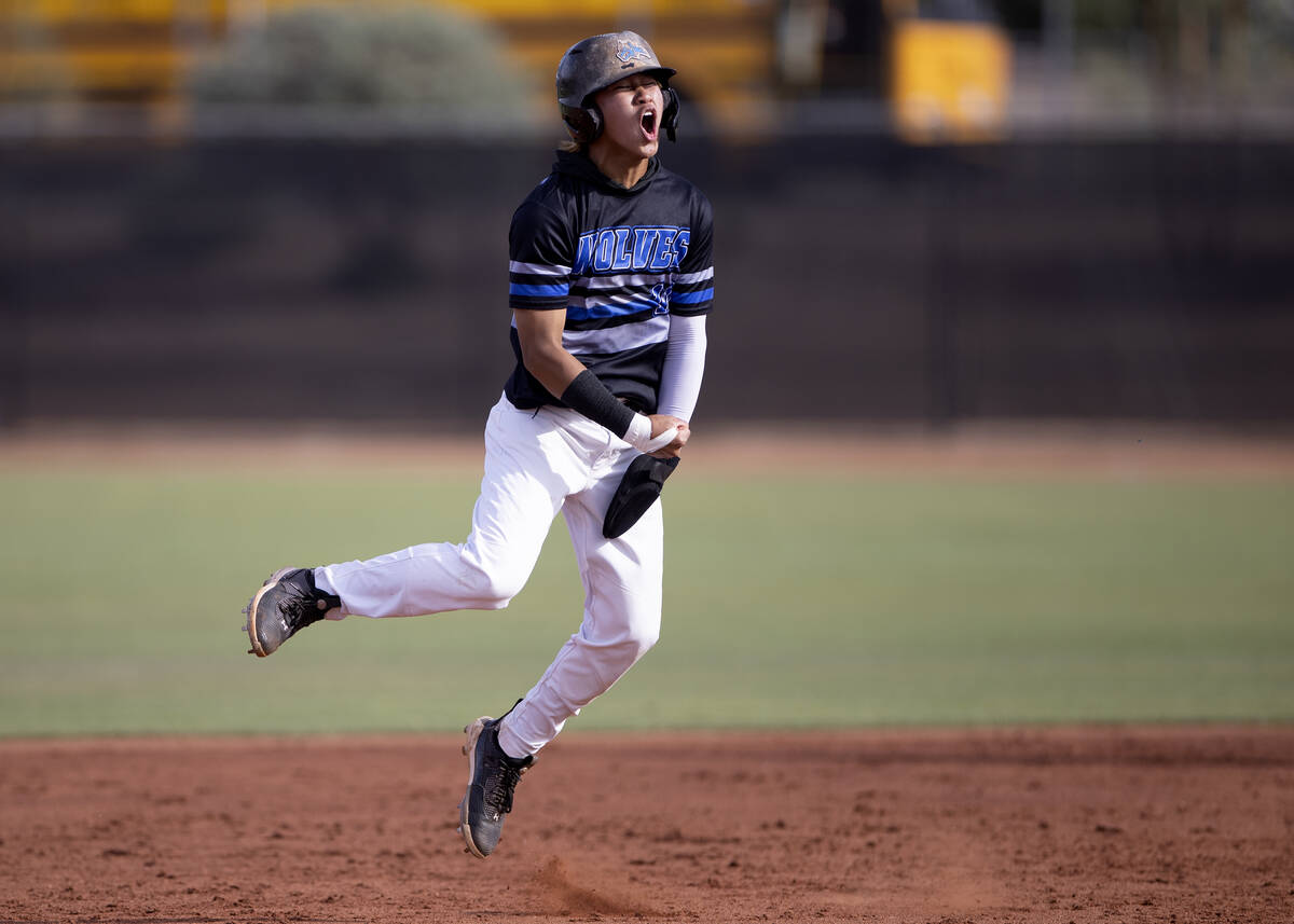 Basic’s Troy Southisene celebrates after hitting a double that scored two RBIs for his t ...