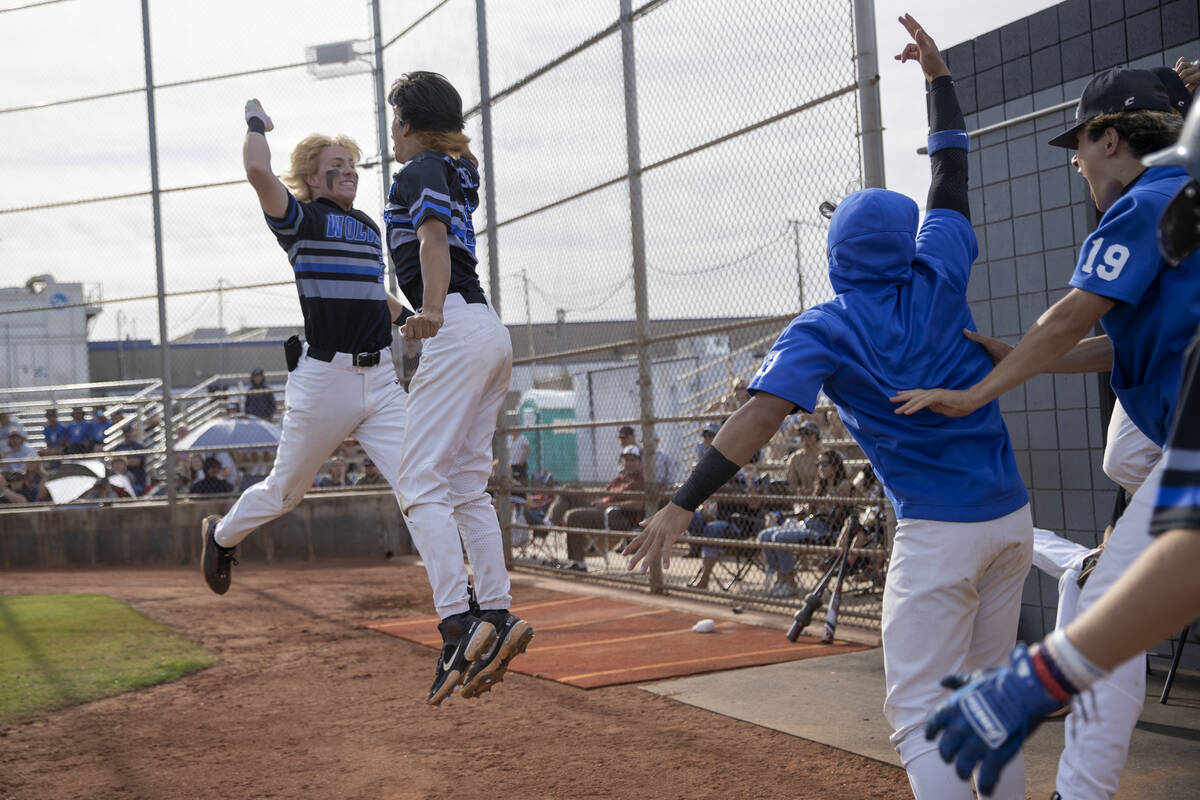 Basic’s Andruw Giles, left, and Tate Southisene, center right, celebrate after Giles sco ...