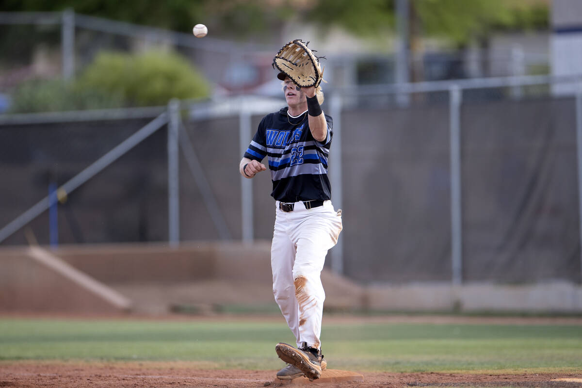 Basic’s Cooper Sheff catches for an out against Coronado at first base during a high sch ...