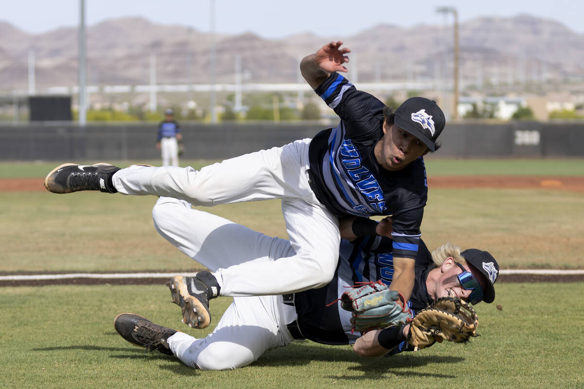 Basic’s Tate Southisene, above, and Cooper Sheff collide while going for a foul ball dur ...