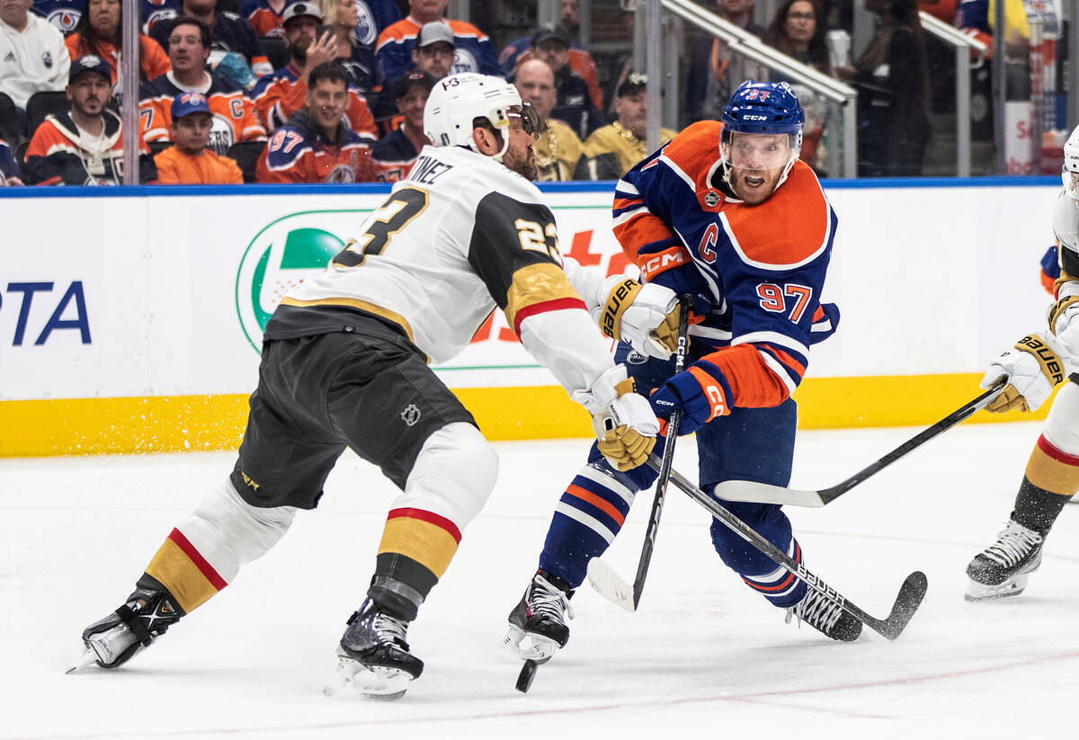 Vegas Golden Knights' Alec Martinez (23) tries to stop Edmonton Oilers' Connor McDavid (97) dur ...