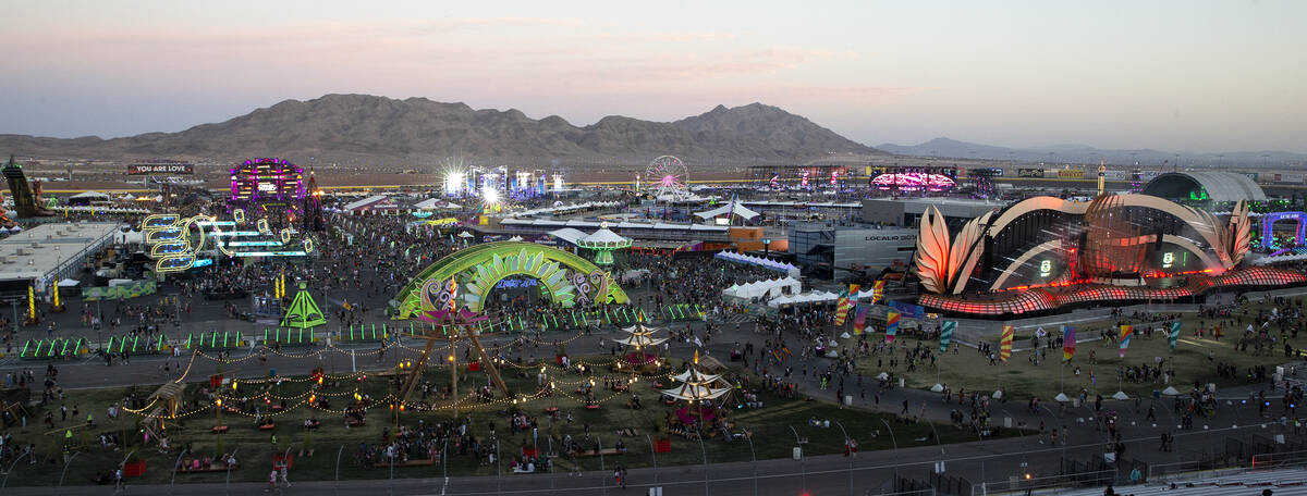 Attendees of the Electric Daisy Carnival file in as the sun sets over the Las Vegas Motor Speed ...