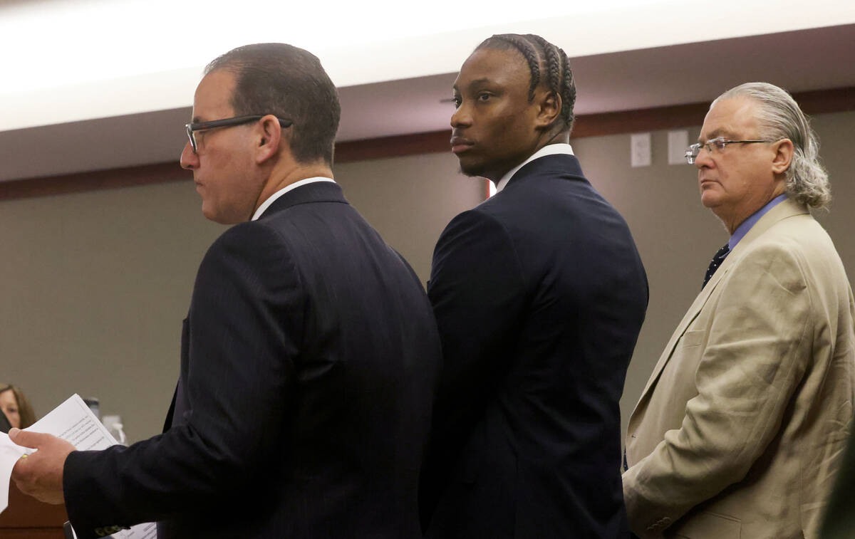 Former Raiders player Henry Ruggs, center, appears in court with his attorneys Michael Schonfel ...