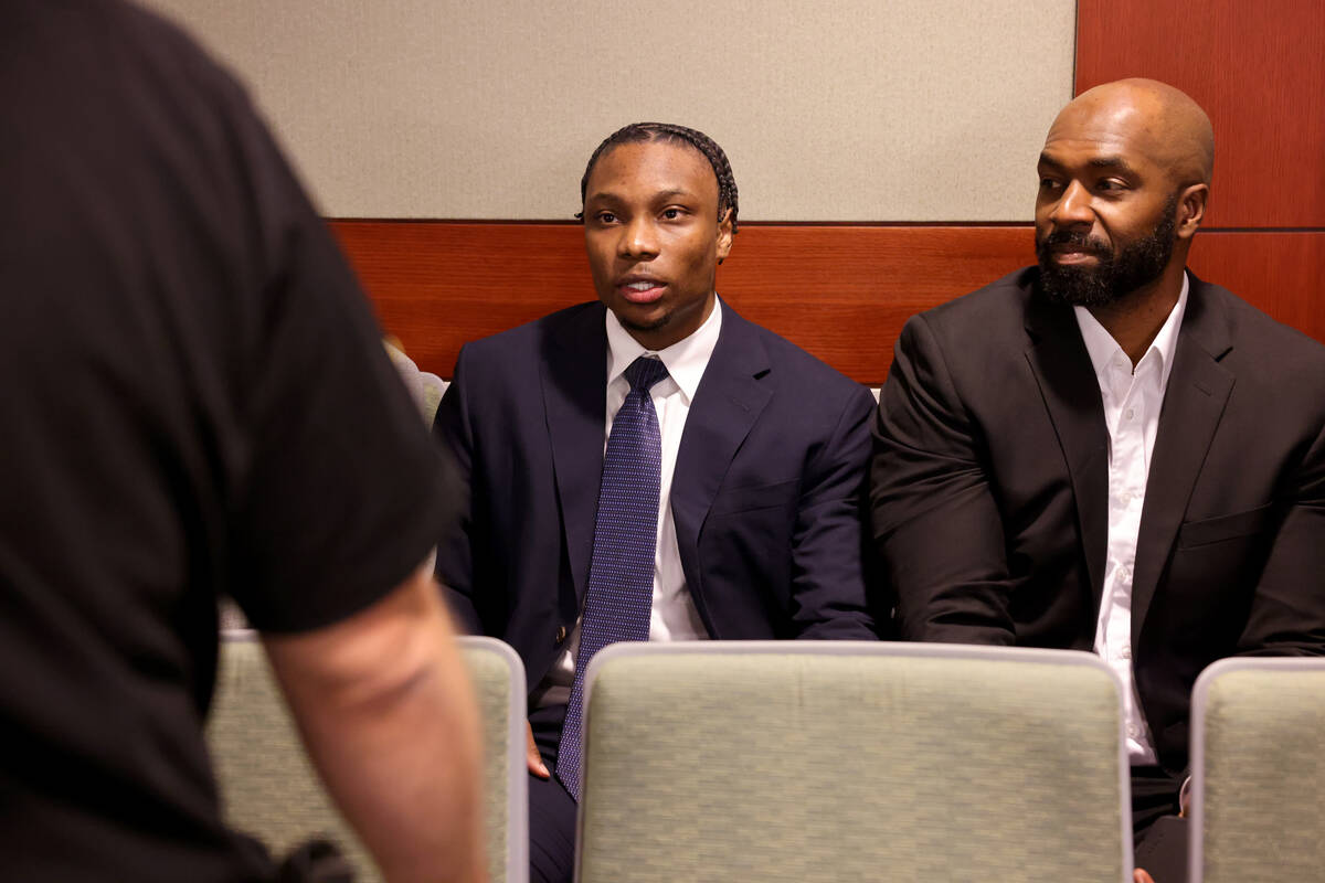 Former Raiders player Henry Ruggs, left, waits to appear in court at the Regional Justice Cente ...