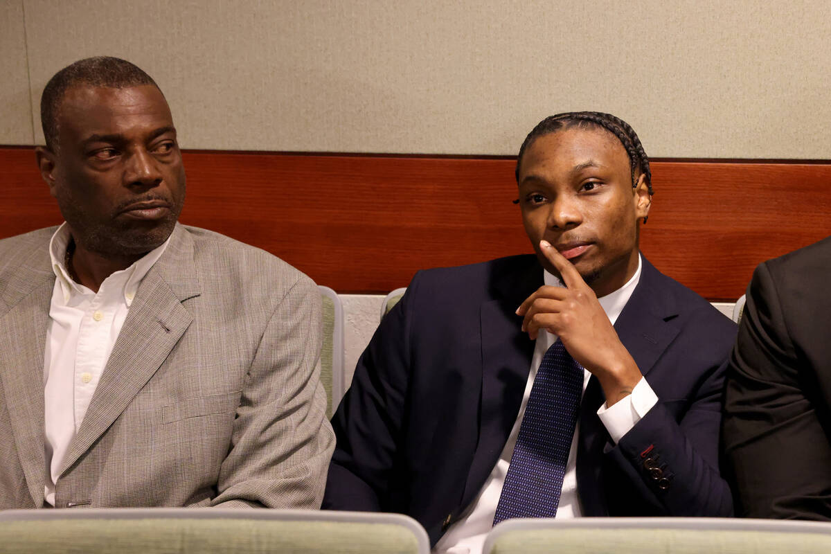 Former Raiders player Henry Ruggs, center, waits to appear in court at the Regional Justice Cen ...