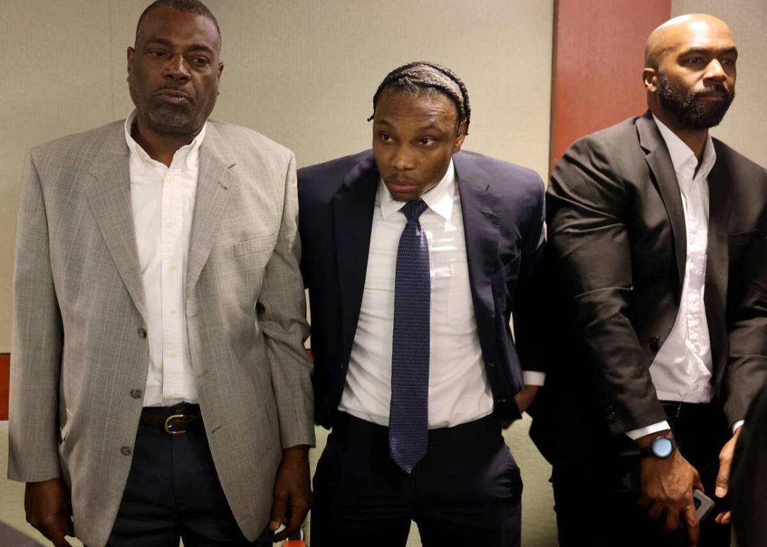 Former Raiders player Henry Ruggs, center, stands as the judge enters the courtroom at the Regi ...