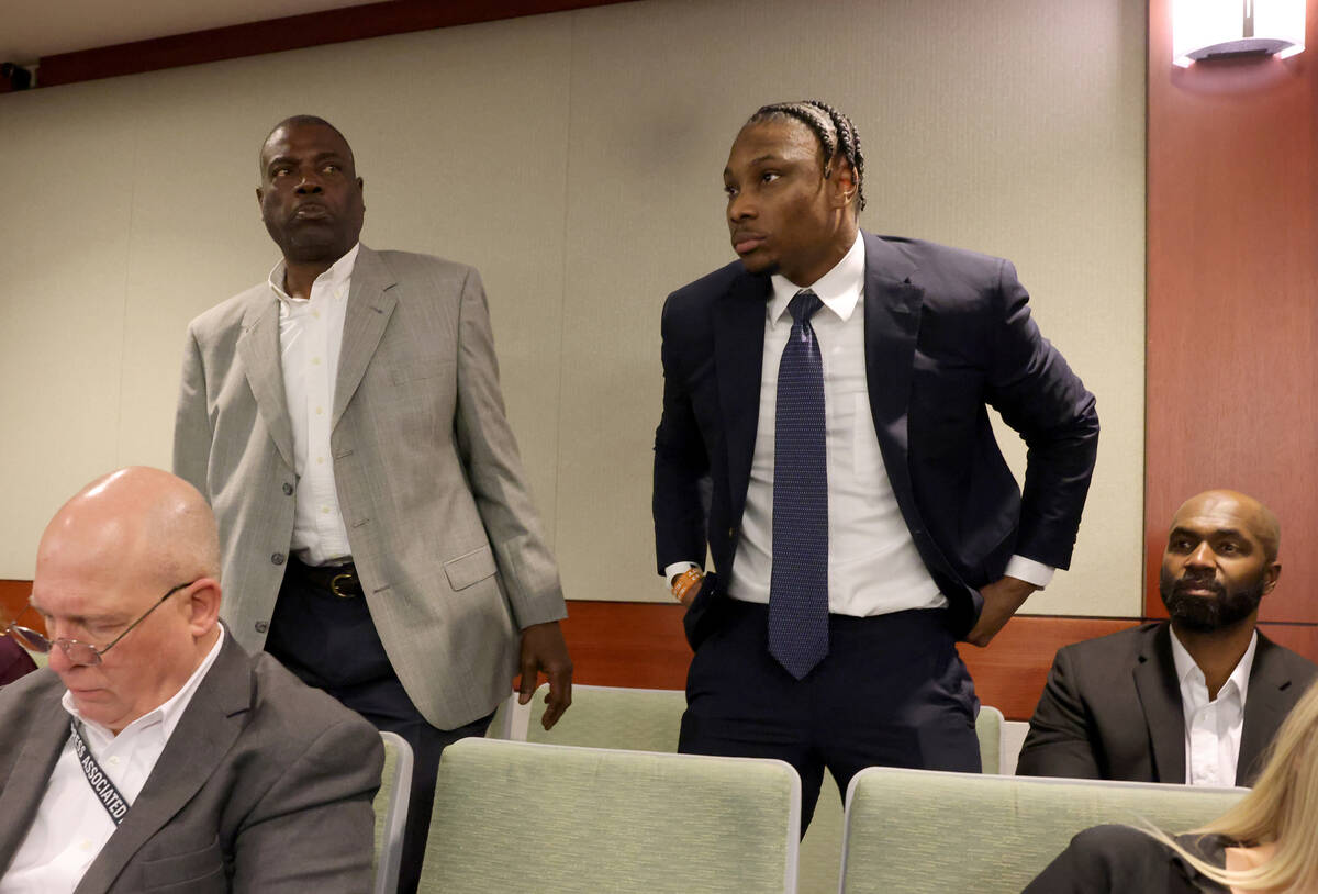 Former Raiders player Henry Ruggs, right, stands to appear in court at the Regional Justice Cen ...