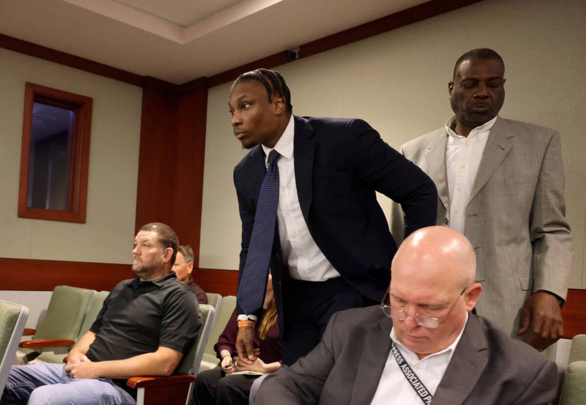 Former Raiders player Henry Ruggs, right, stands to appear in court at the Regional Justice Cen ...