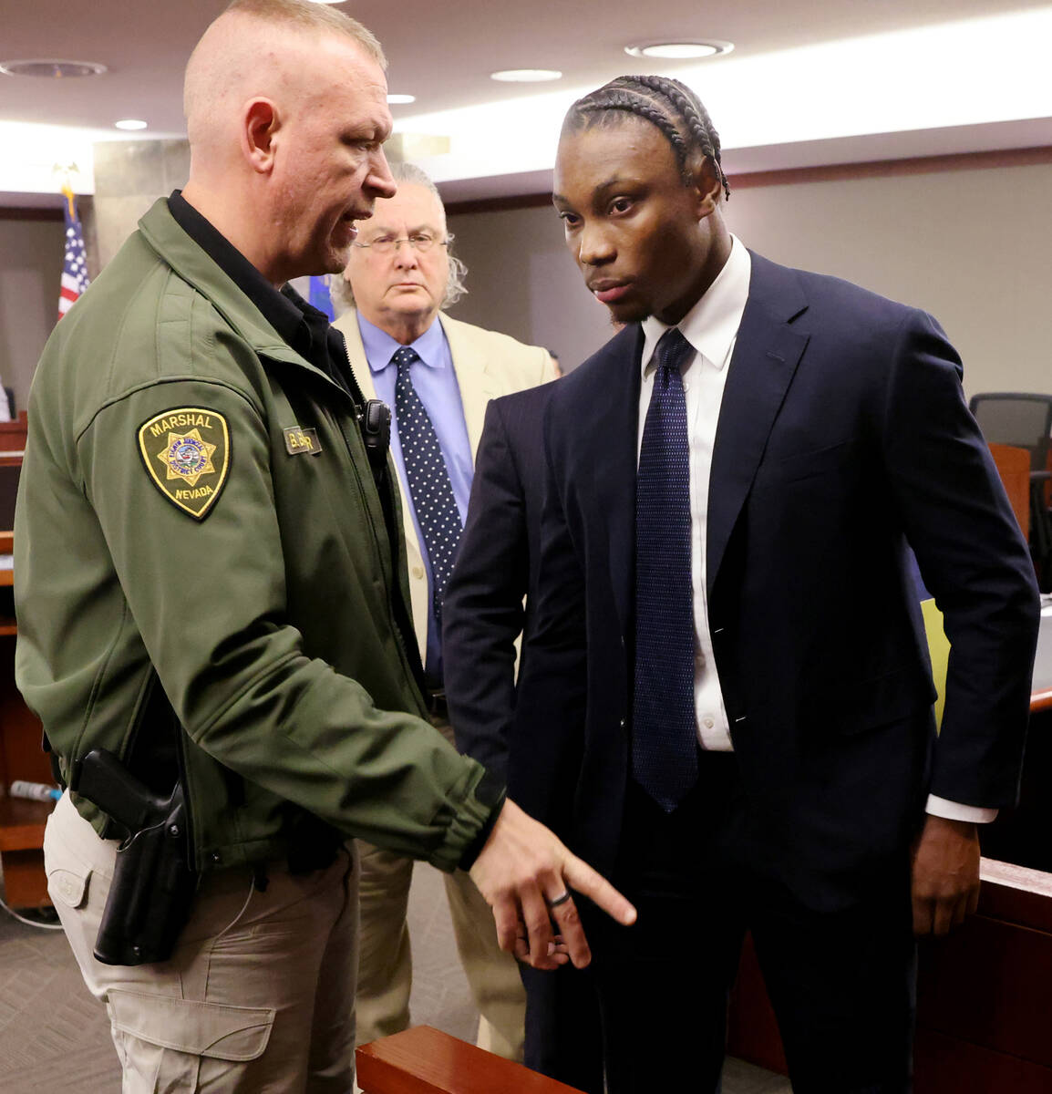 Former Raiders player Henry Ruggs, right, prepares to leave the courtroom on Wednesday, May 11, ...