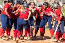 Liberty High's Jesse Farrell (17) is greeted by her teammates after hitting a solo homer agains ...