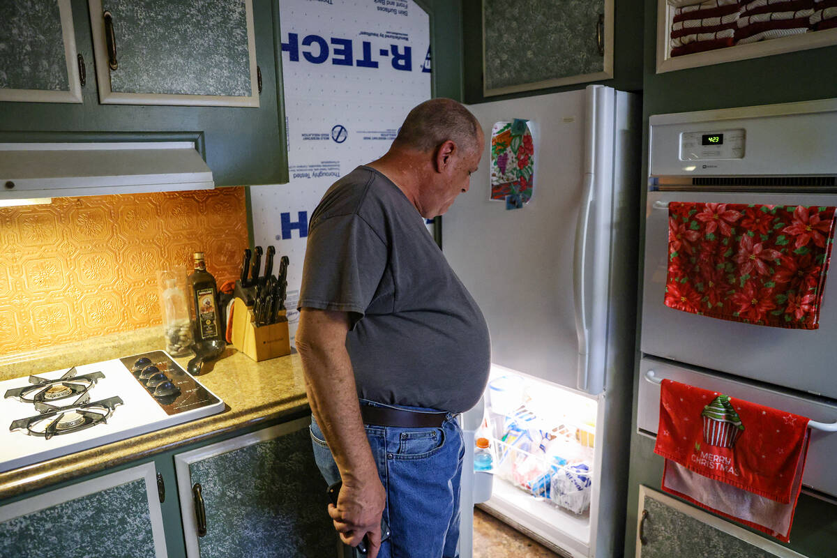 Anthony Smith shows the Review-Journal his fridge and other utilities at his mobile home at the ...