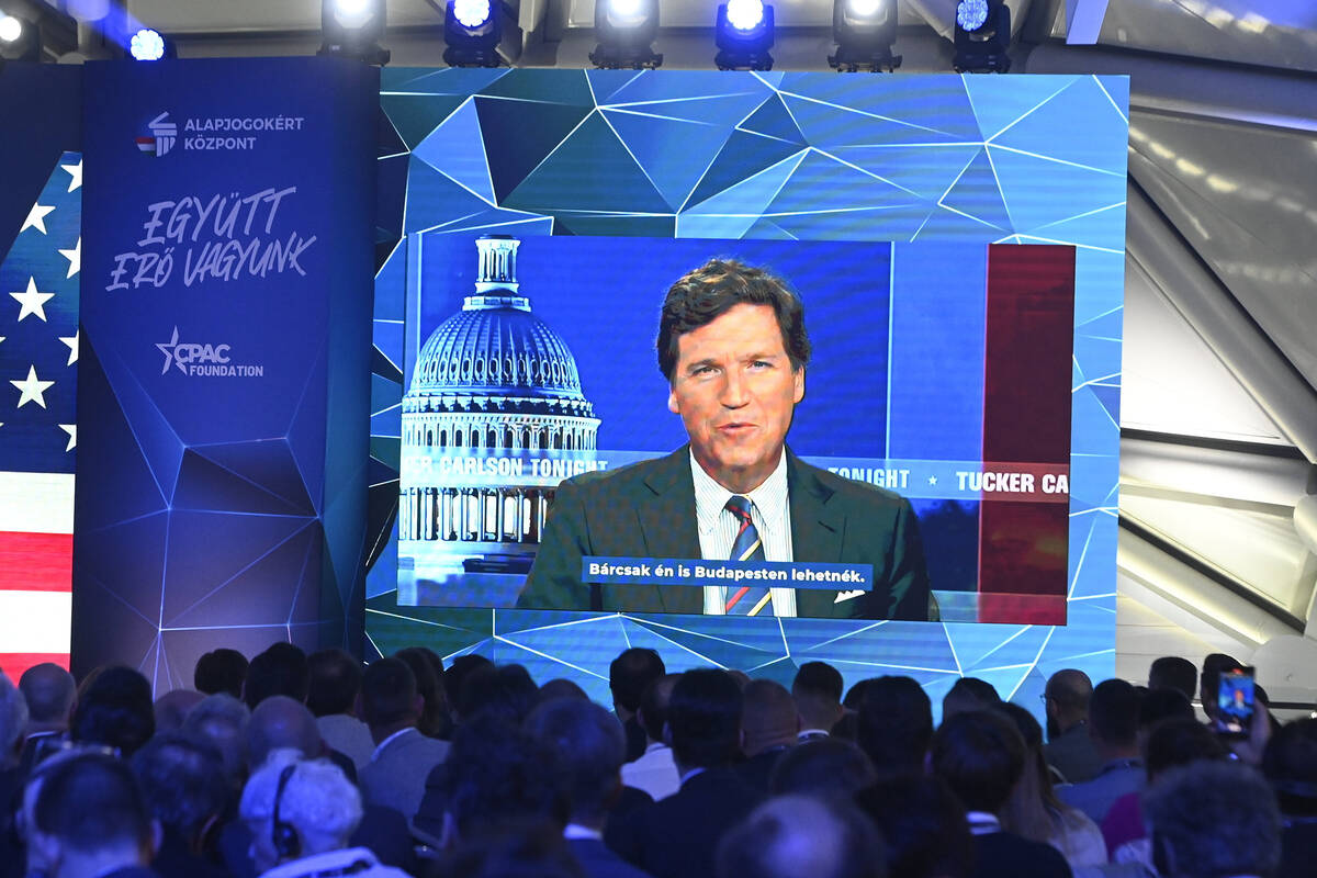 American media personality Tucker Carlson appears on the screen during the opening session of H ...