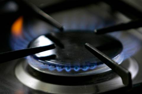 FILE - A gas-lit flame burns on a natural gas stove. The city of Berkeley, Calif., will likely ...
