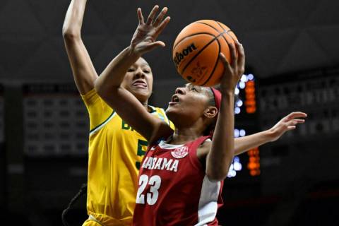 Alabama's Brittany Davis (23) goes up to the basket as Baylor's Darianna Littlepage-Buggs (5) d ...
