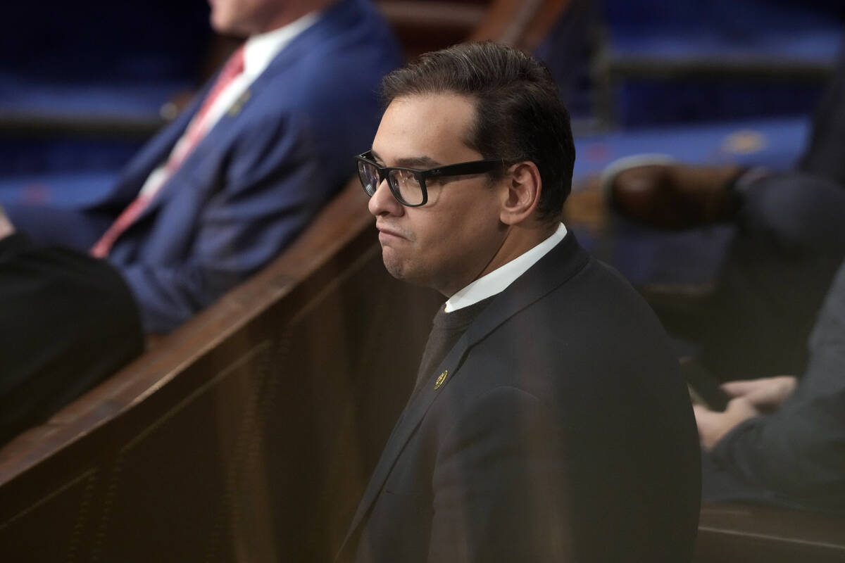 FILE - Then Rep-elect George Santos, R-N.Y., stands in the House chamber as the House meets for ...
