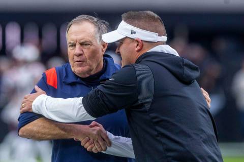 Raiders Head Coach Josh McDaniels greets New England Patriots Head Coach Bill Belichick during ...