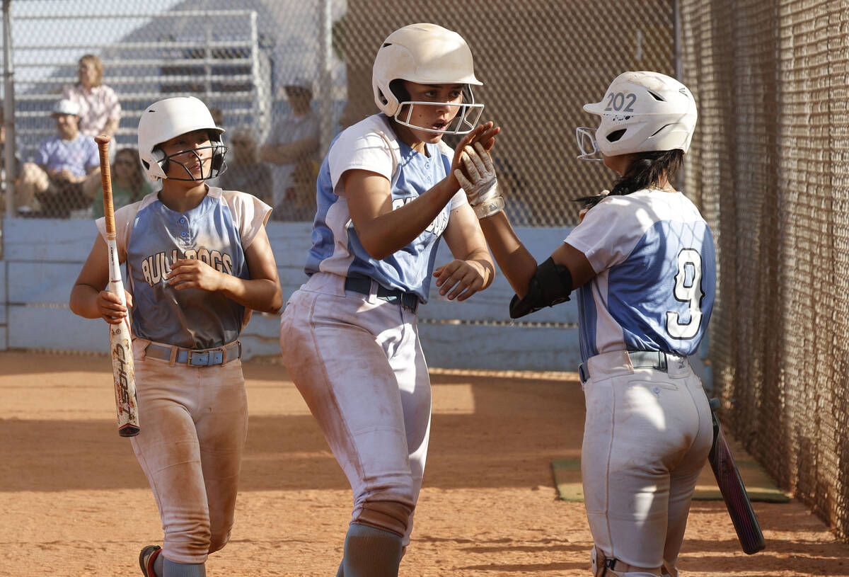 Centennial's Keana Bell (13), center, gets a high-five from Centennial's Amanda Campos-Colon (9 ...