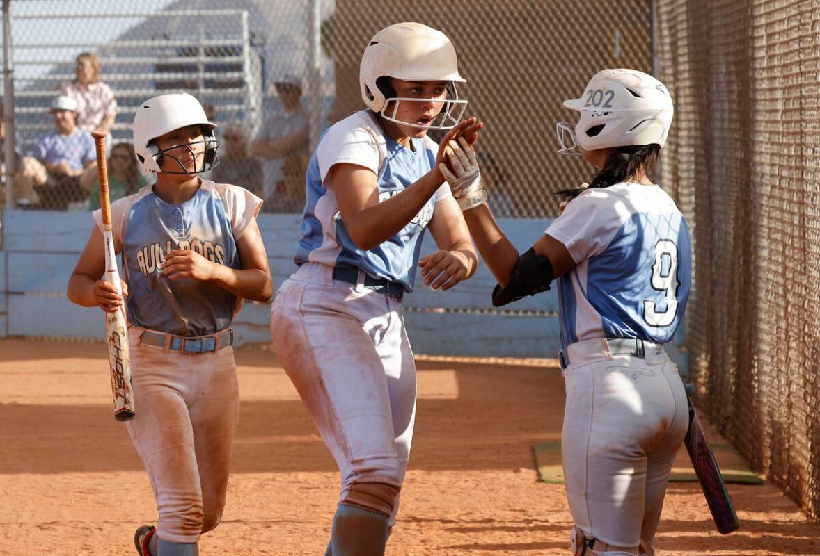 Centennial's Keana Bell (13), center, gets a high-five from Centennial's Amanda Campos-Colon (9 ...