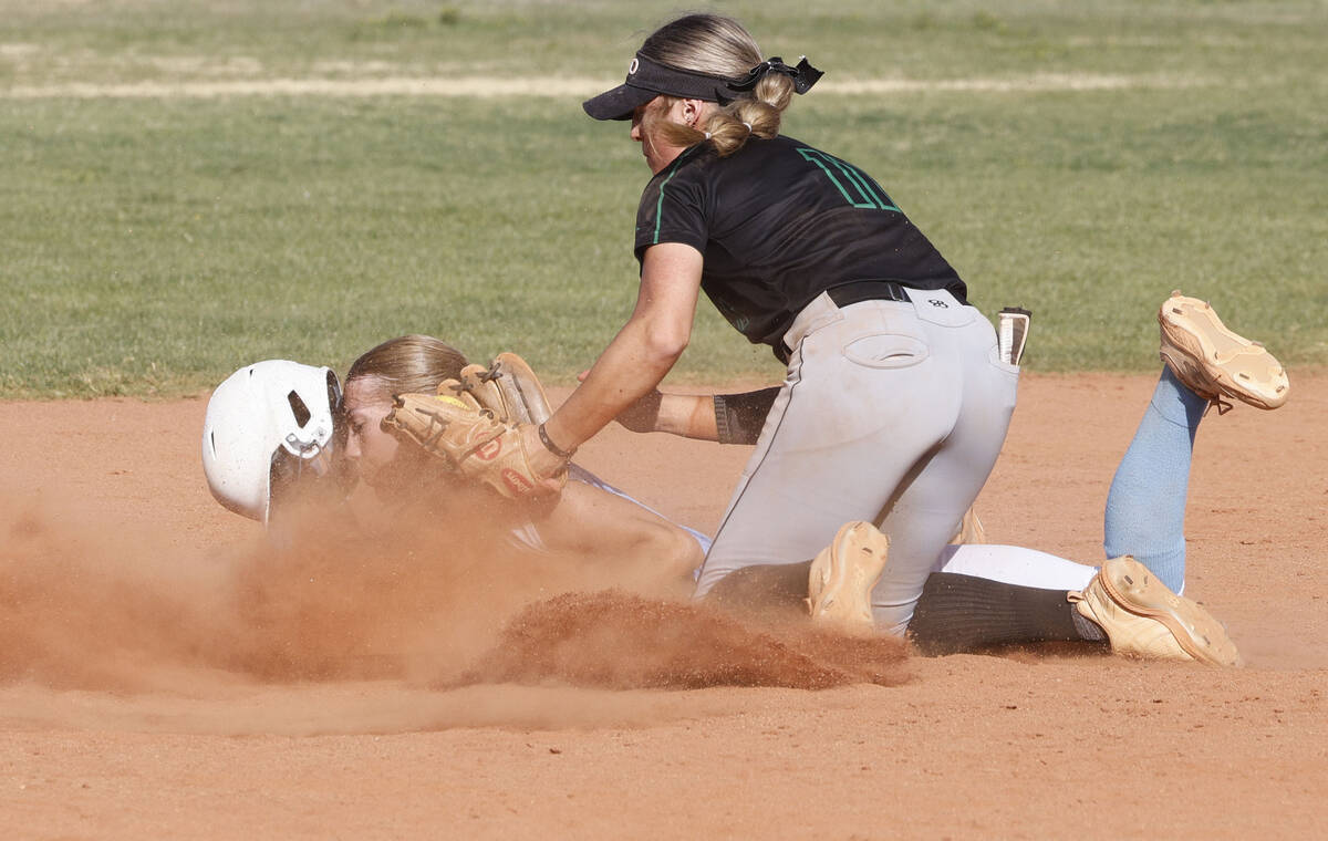 Centennial's Jill Halas (11), left, is tagged out by Palo Verde's Taylor Johns (11) during the ...