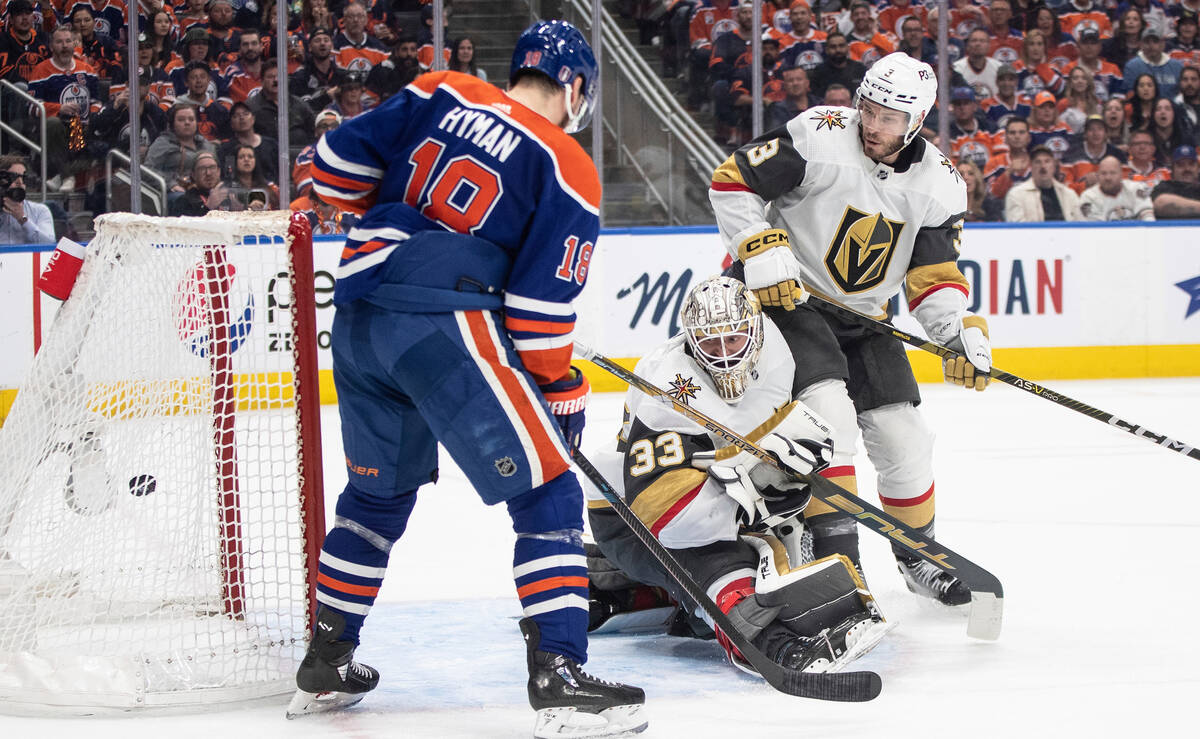 Vegas Golden Knights' goalie Adin Hill (33) gives up a goal to the Edmonton Oilers as Oilers' Z ...