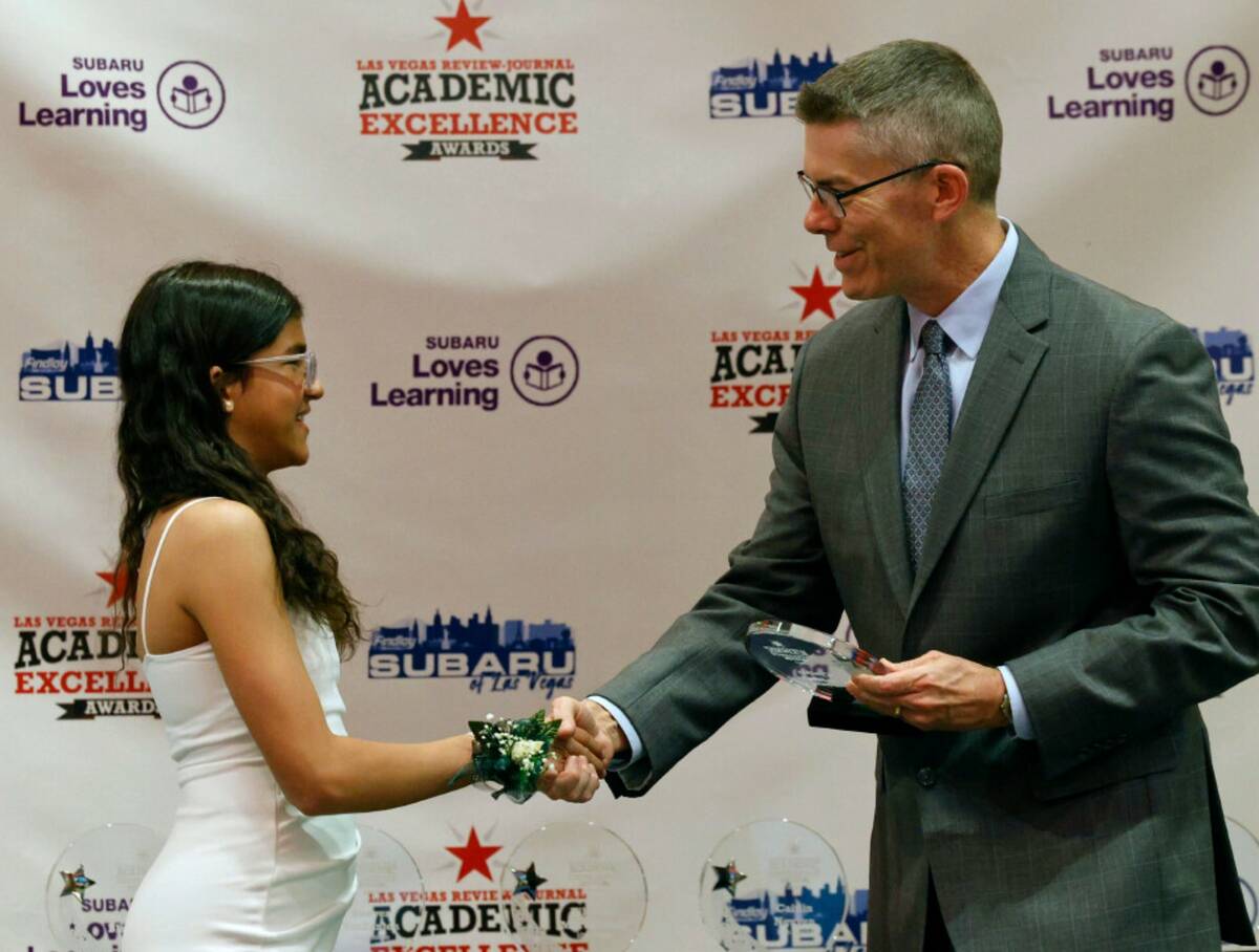 Cynthia Srinarayana, fifth grader of Staton Elementary School, shakes hands with Glenn Cook, La ...