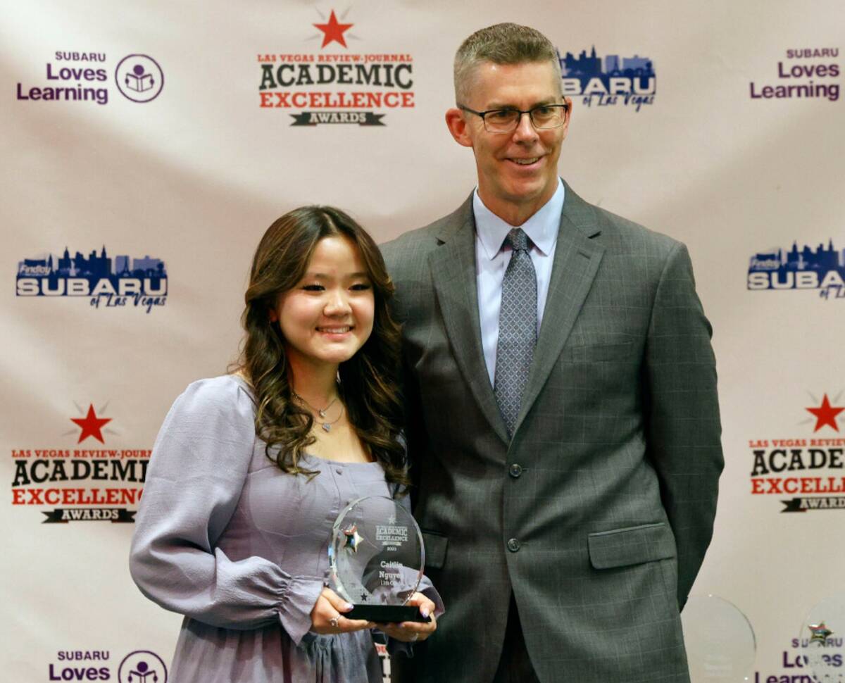 Caitlin Nguyen, 11th grader of Coral Academy of Science Las Vegas, poses for a photo with Glenn ...