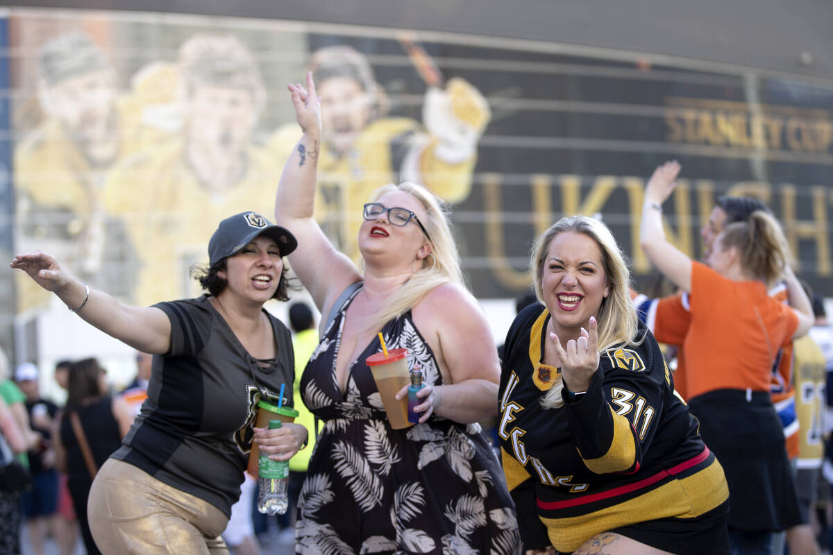 Theresa Unis, left, Kat Seeker and Breigh Redding dance outside T-Mobile Arena before Game 5 of ...