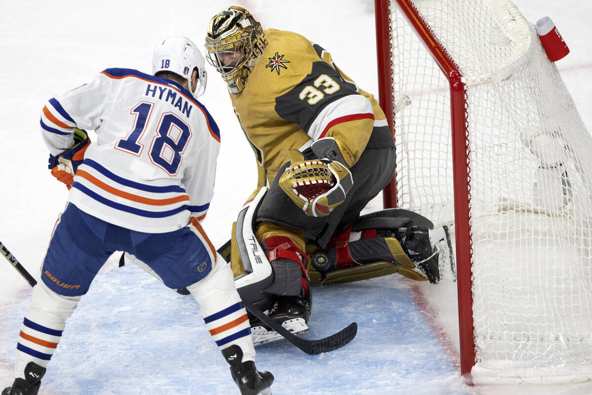 Edmonton Oilers left wing Zach Hyman (18) scores on Golden Knights goaltender Adin Hill (33) du ...