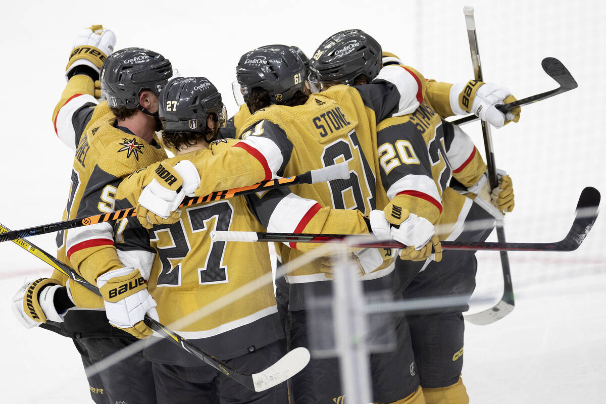 The Golden Knights gather around Golden Knights right wing Mark Stone (61) after he scored duri ...