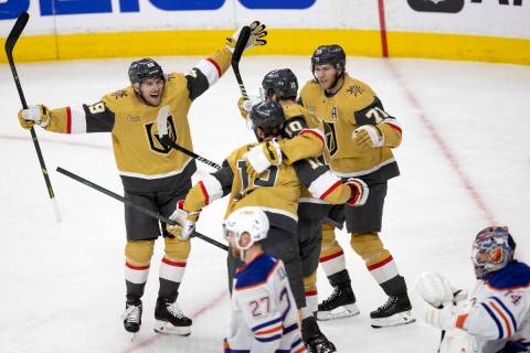 The Golden Knights including center Ivan Barbashev (49) gather around right wing Reilly Smith ( ...