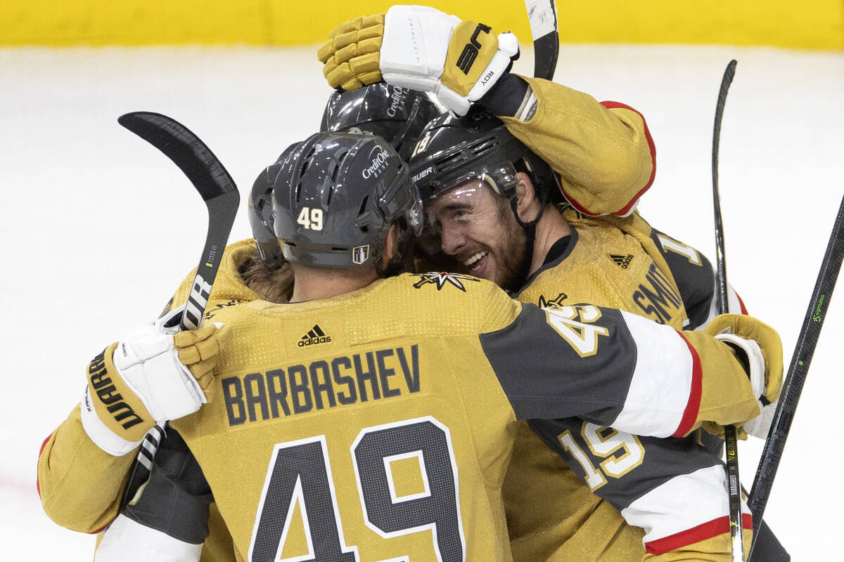 The Golden Knights embrace right wing Reilly Smith (19) after he scored during the second perio ...
