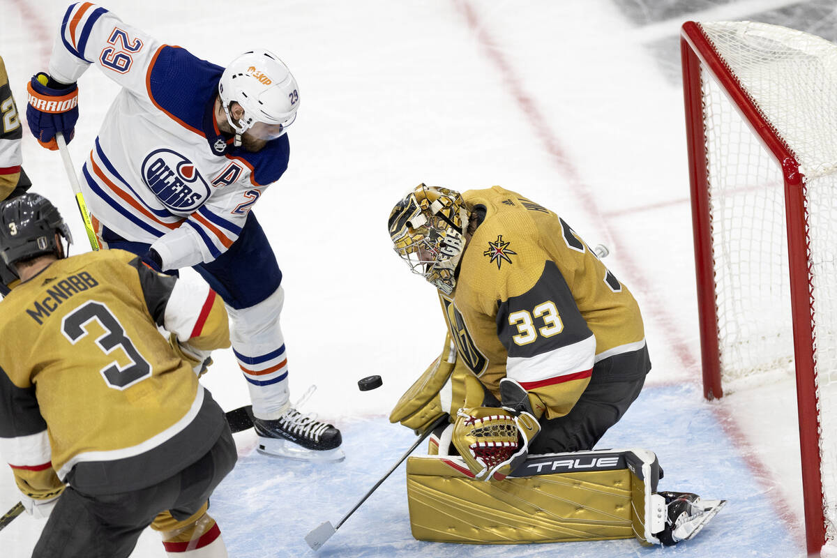Golden Knights goaltender Adin Hill (33) saves the puck against Edmonton Oilers center Leon Dra ...