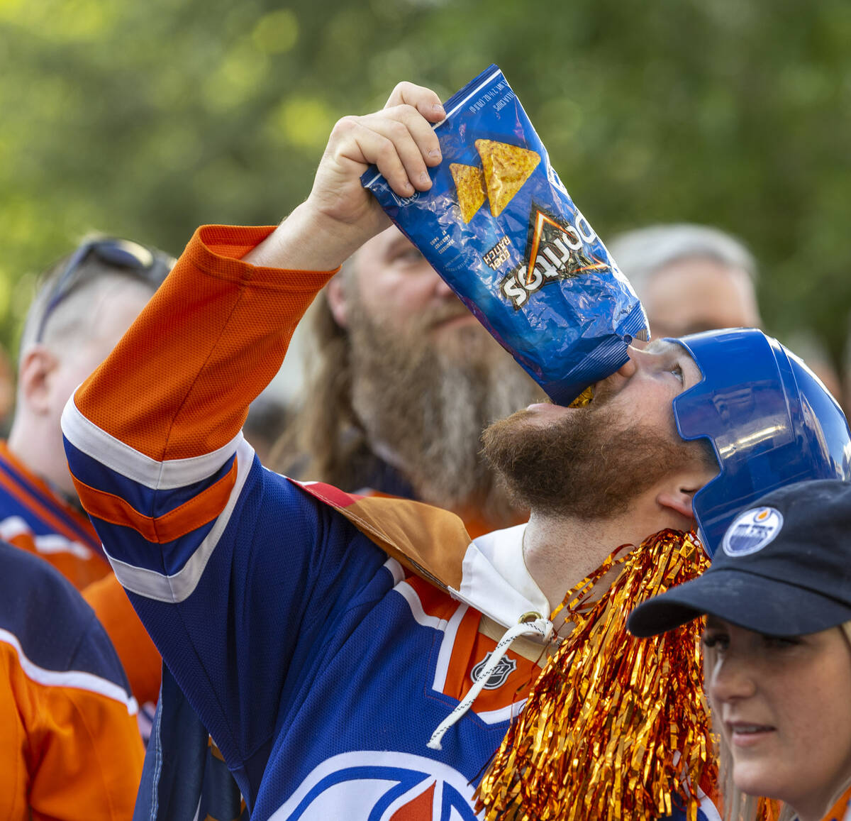 An Edmonton Oilers fan enjoys some Doritos outside before facing the Golden Knights in Game 5 o ...
