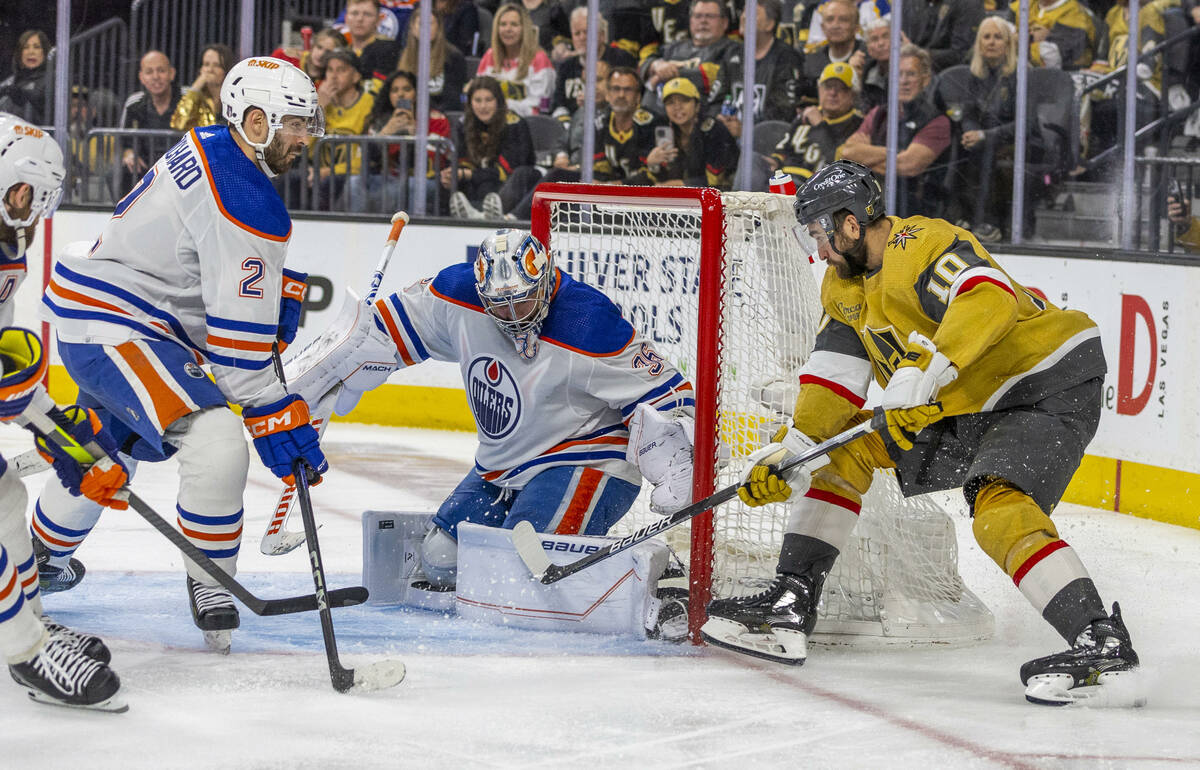 Edmonton Oilers goaltender Jack Campbell (36) traps a shot on goal by Golden Knights center Nic ...