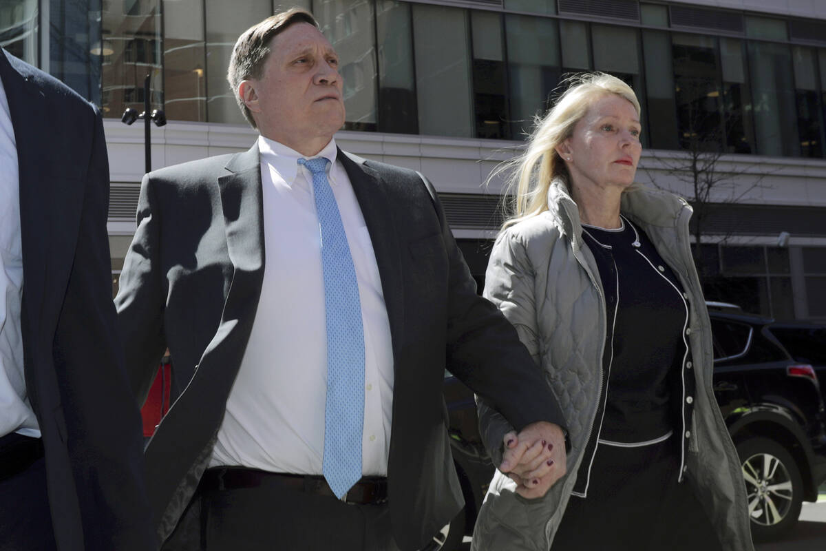 John Wilson arrives at federal court with his wife, Leslie, in Boston on April 3, 2019, to face ...