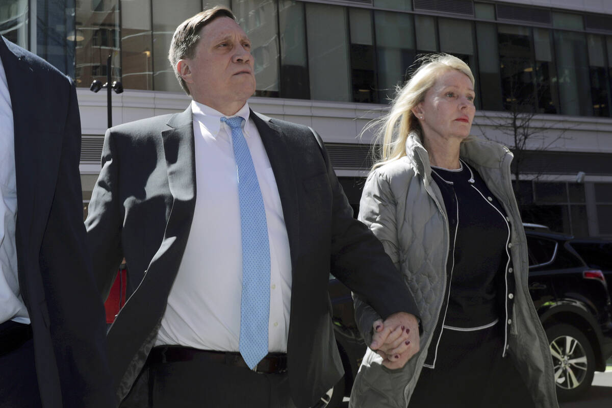 John Wilson arrives at federal court with his wife, Leslie, in Boston on April 3, 2019, to face ...