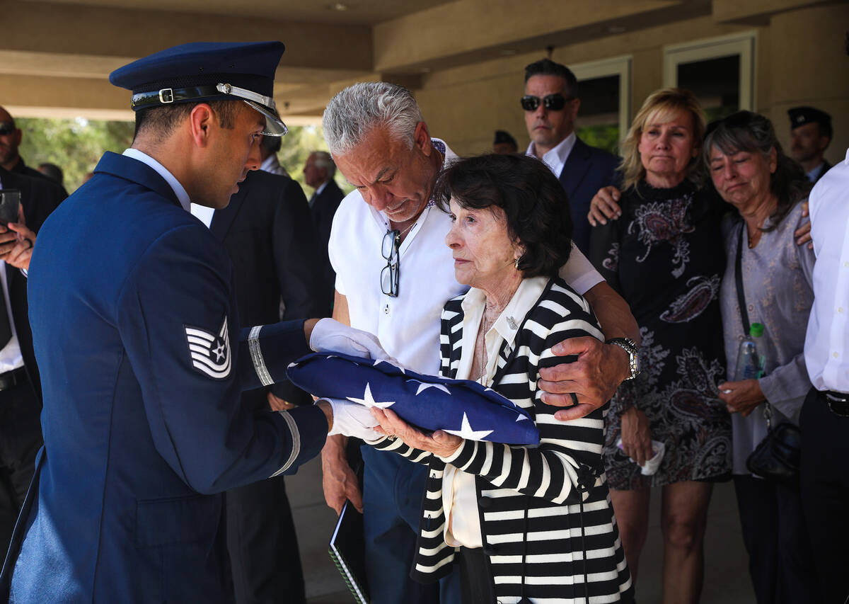 An Air Force member presents a flag to the late Air Force Col. James Abraham’s wife, Jo ...