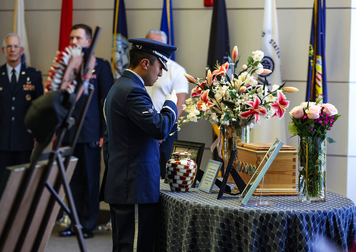 An Air Force member salutes the urn of Air Force Col. James Abraham at his funeral at the South ...