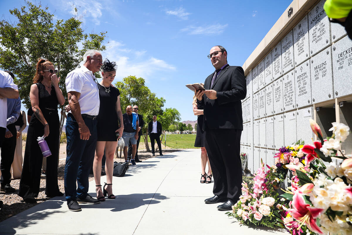 Chaplin Matt Metevelis reads scripture to friends and family at the interning of Air Force Col. ...