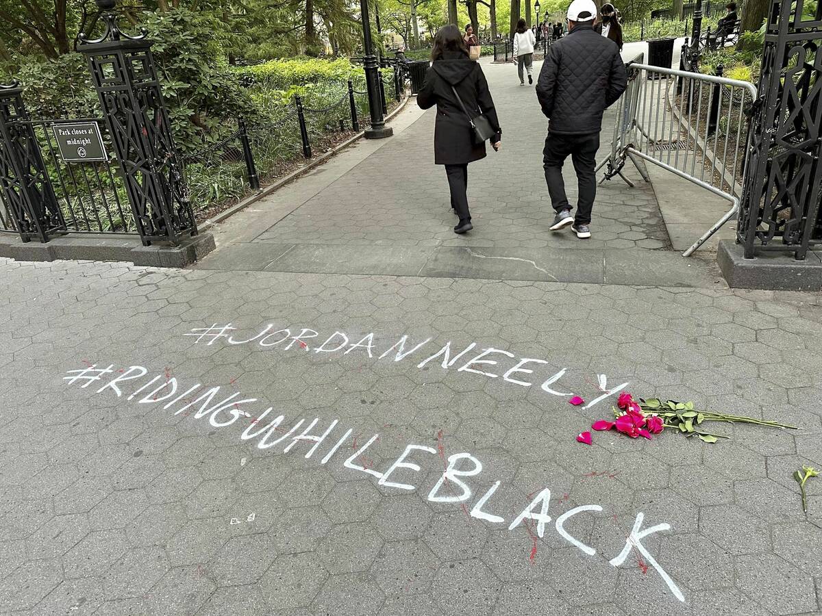FILE - People walk past graffiti calling attention to death of Jordan Neely that was painted on ...