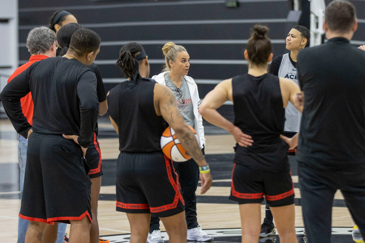 Las Vegas Aces head coach Becky Hammon, center, meets with her team during a team practice at t ...