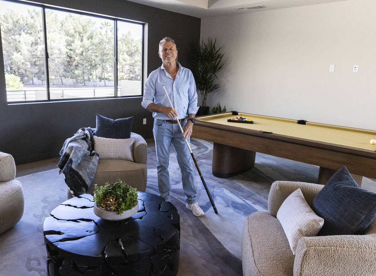 Chris Beucler, president of Blue Heron Nexus, poses for a photo at the newly finished house at ...